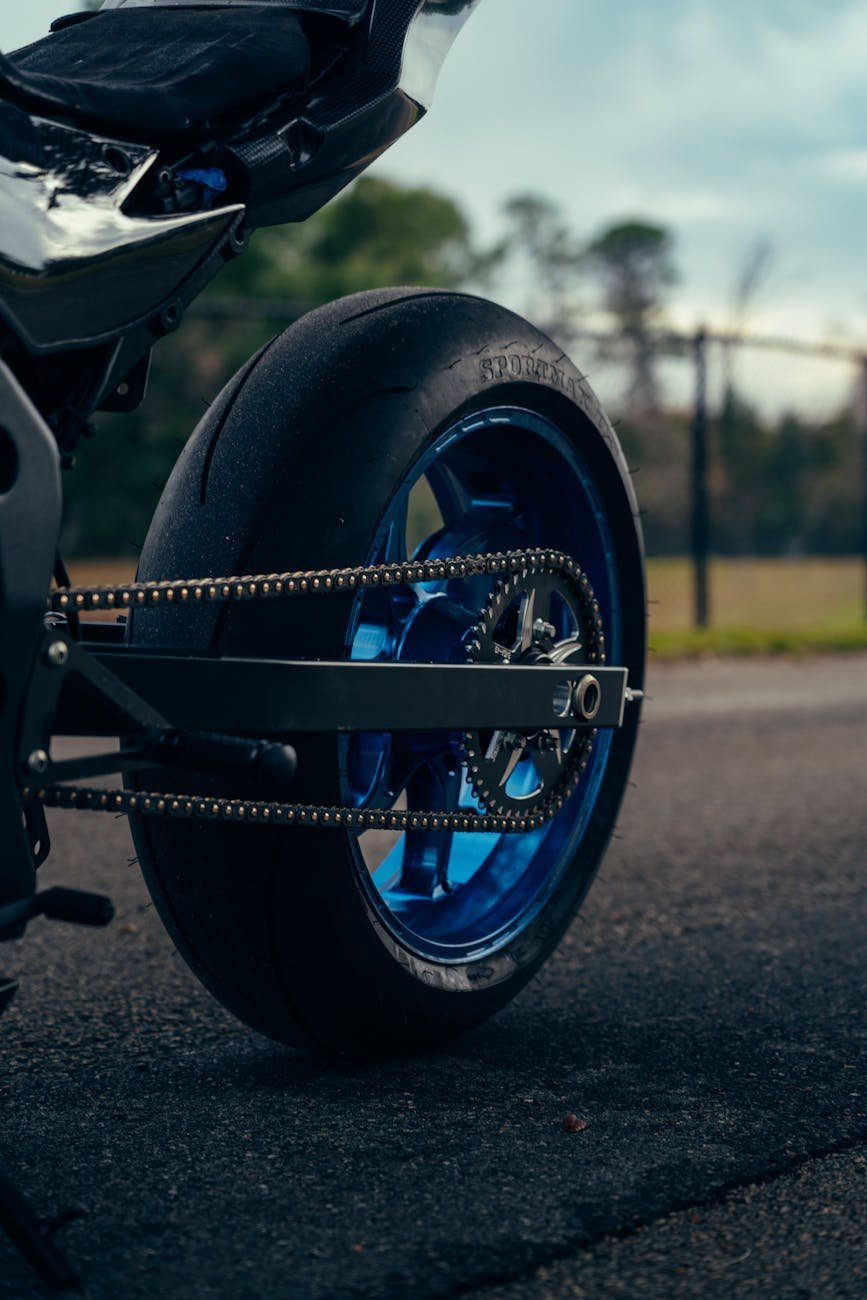 close up of motorcycle rear wheel on road