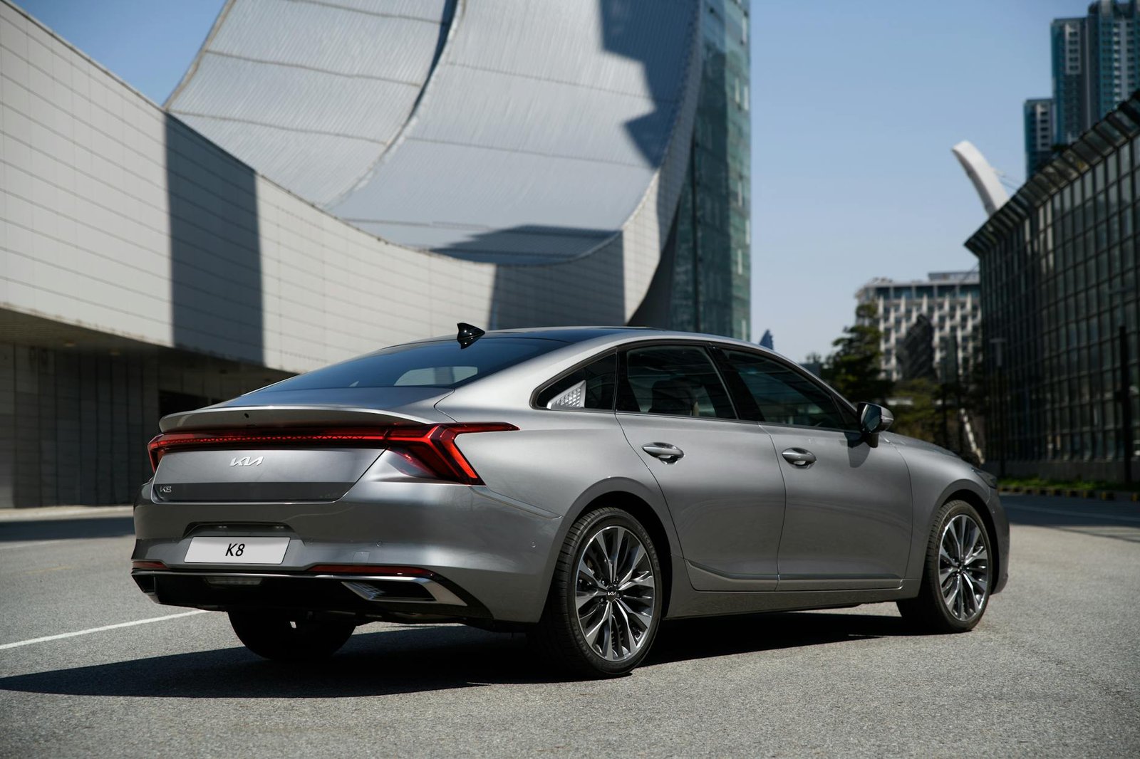 a gray car parked near gray building