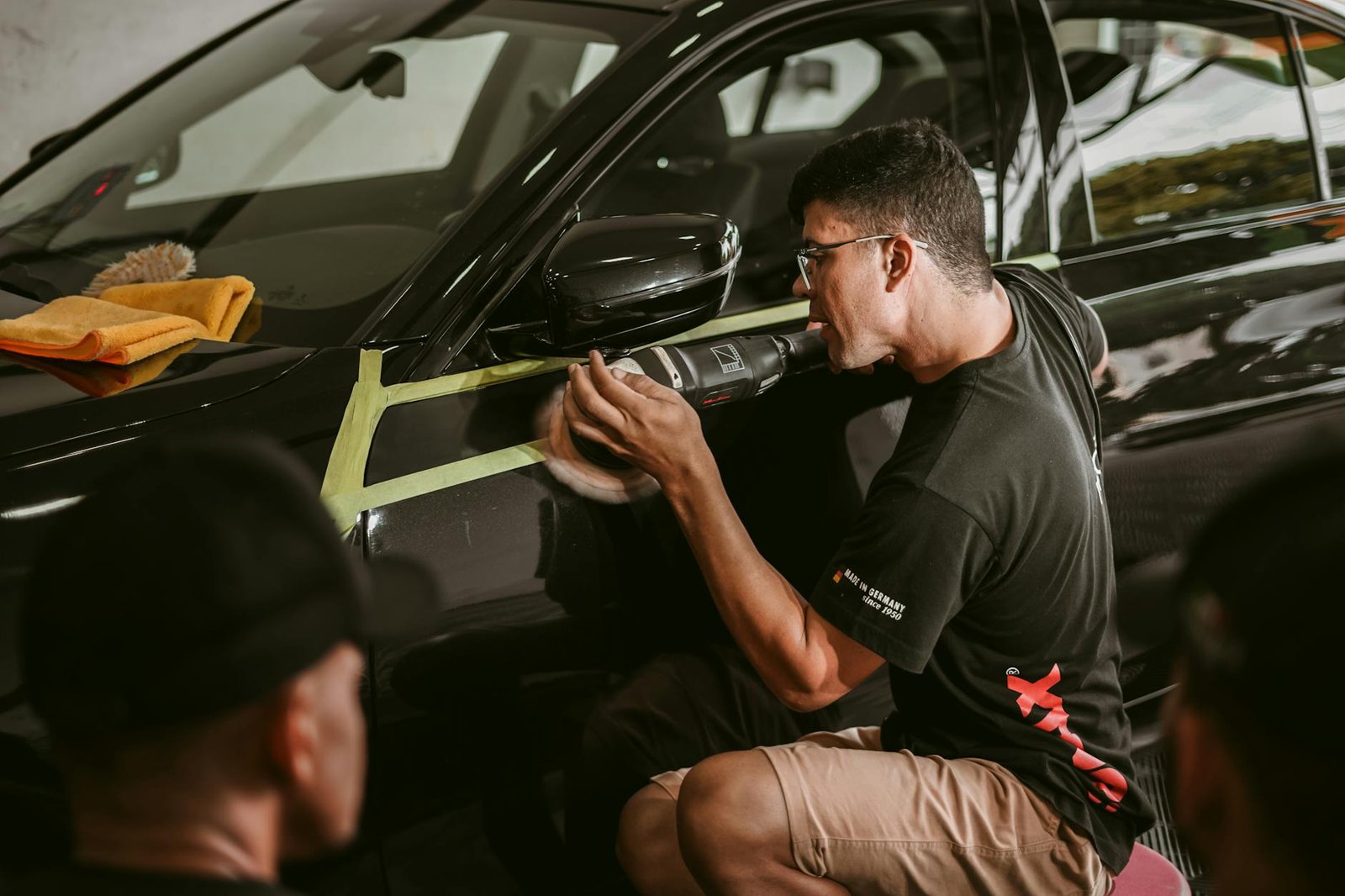 man polishing a car