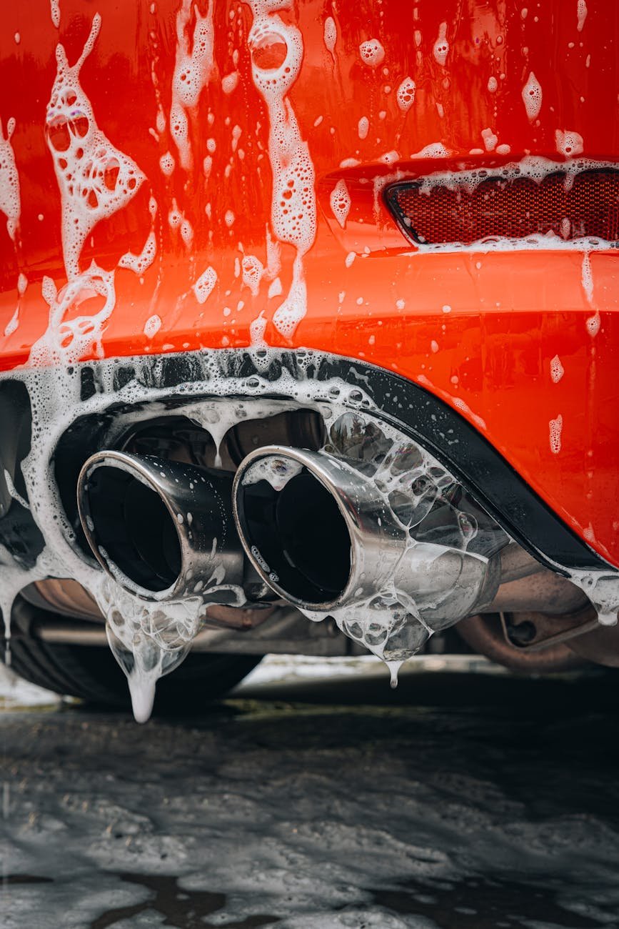 close up of a red car covered in foam
