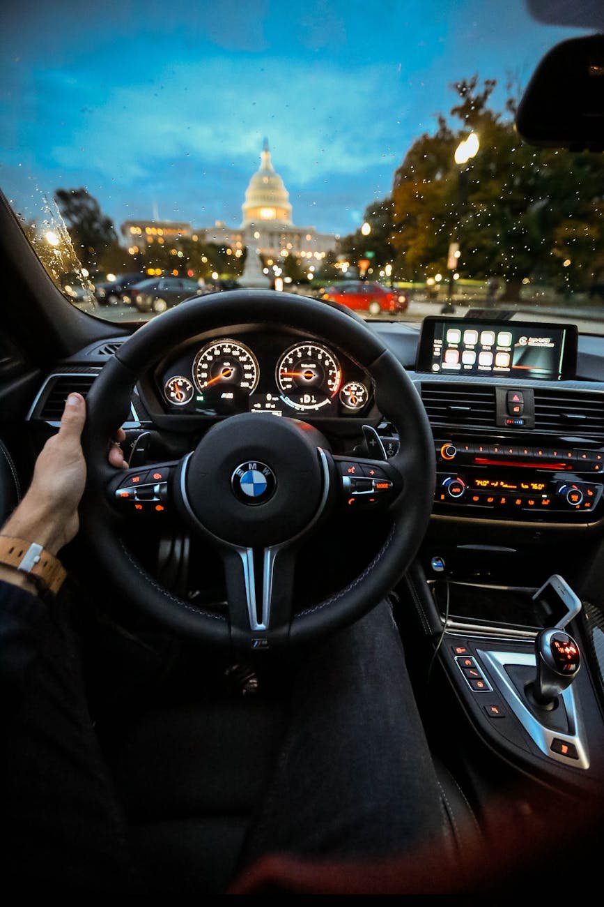 person holding bmw steering wheel