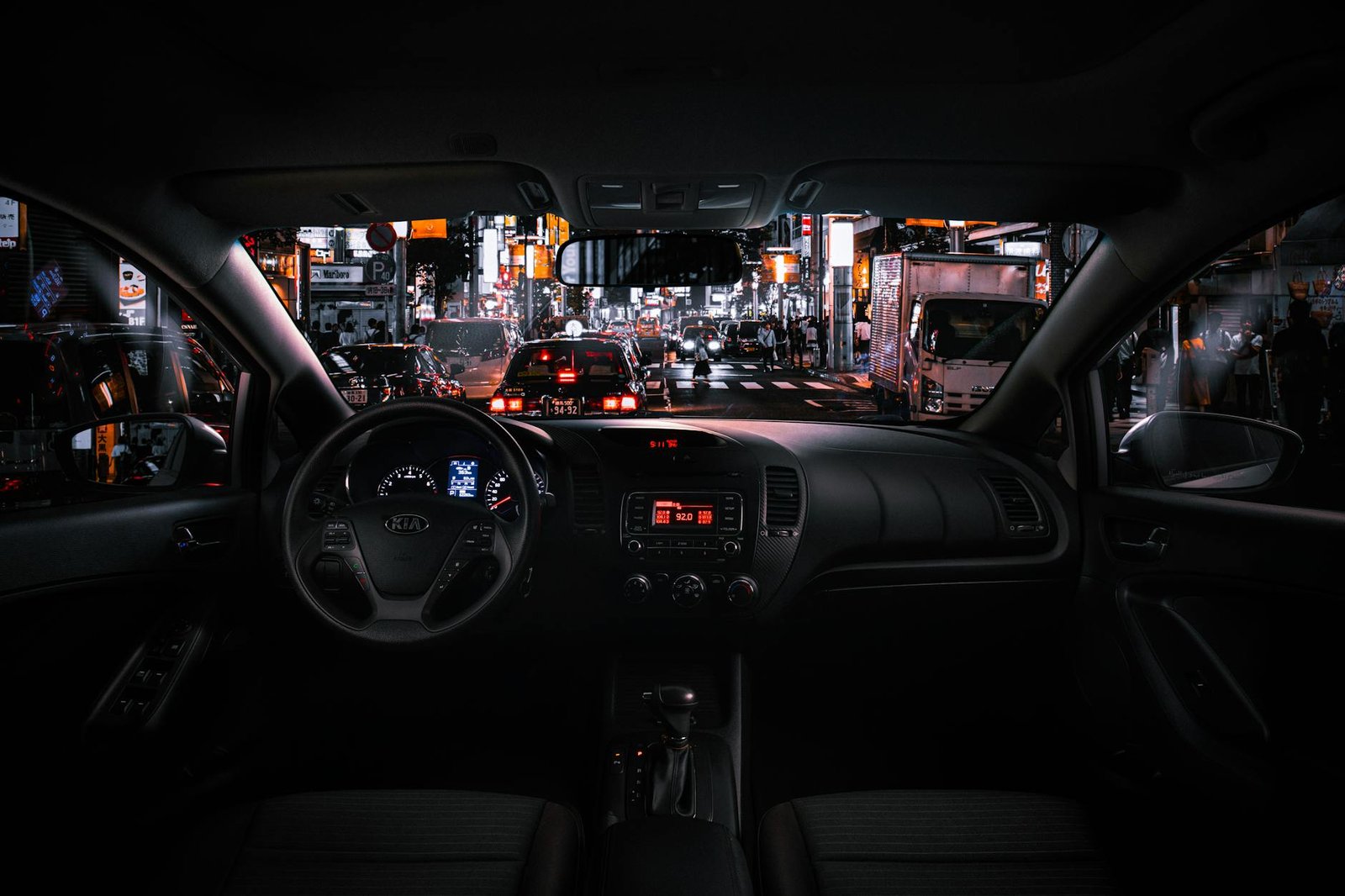 black car steering wheel and interior during night time