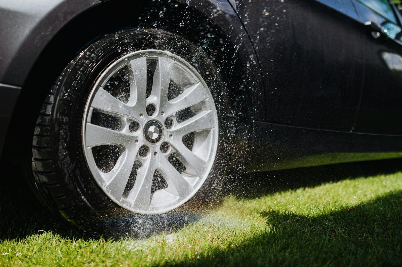 water being sprayed on a wheel of a car