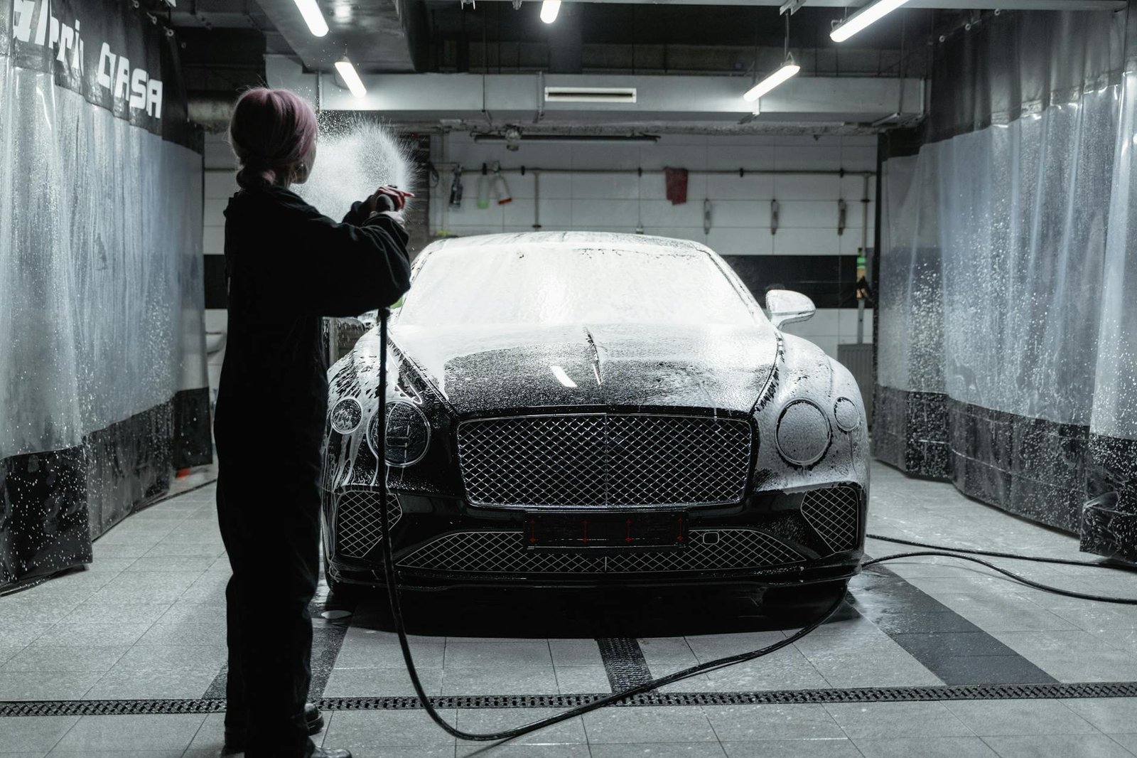 a woman with dyed hair washing a car