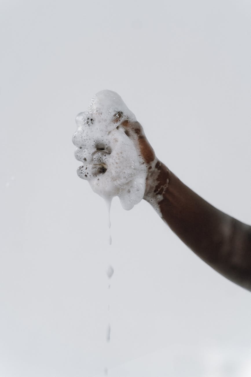 human hand covered in soap foam