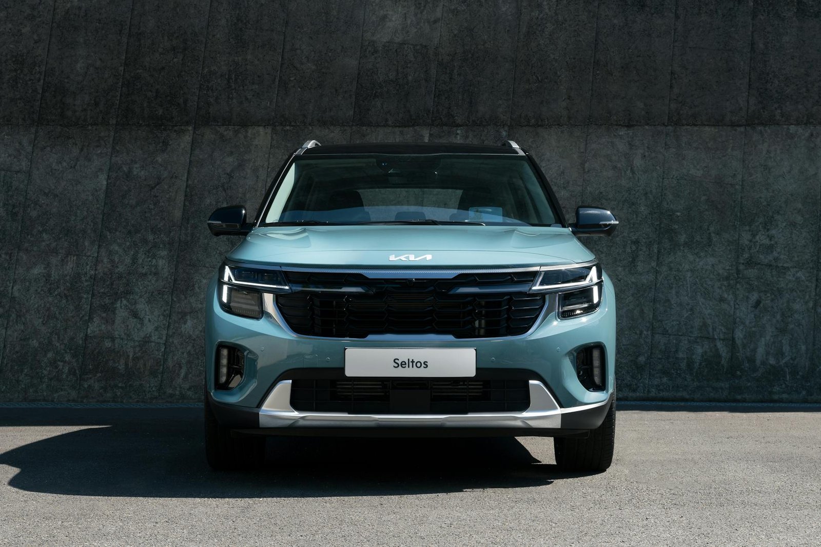 blue car parked on concrete road